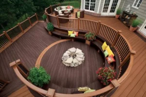 Large custom multi-level curved wood deck with built-in stone fire pit in Cincinnati Ohio