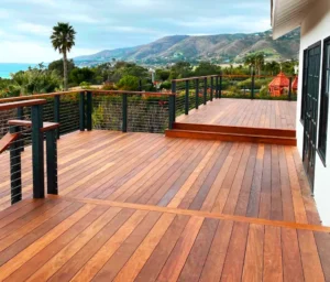 Premium custom hardwood wood deck installation with sleek black cable railings